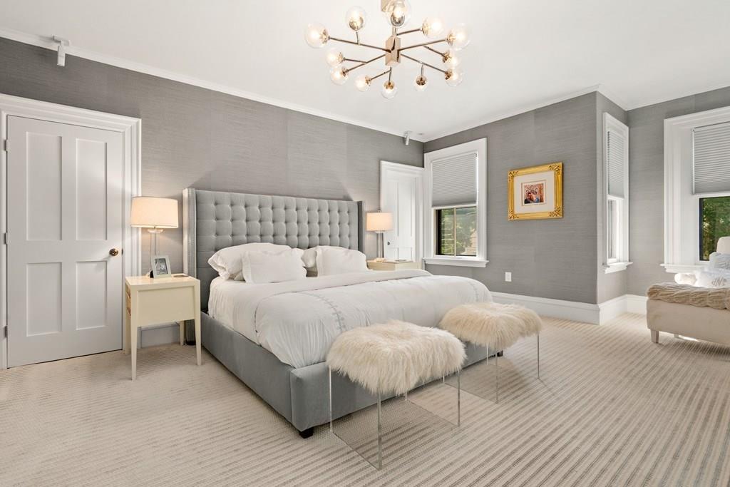 699 Boston Post Road Weston, MA 02493 - Photo 27 of 41 a bedroom with a large bed and a chandelier
