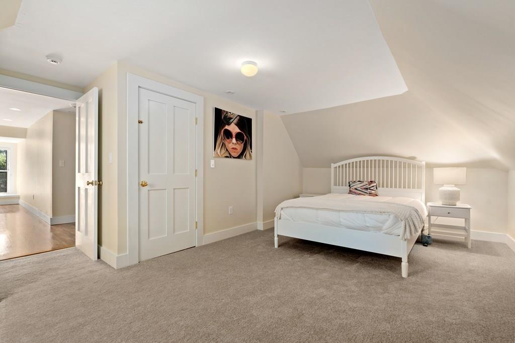 699 Boston Post Road Weston, MA 02493 - Photo 30 of 41 a bedroom with a bed and painting on the wall