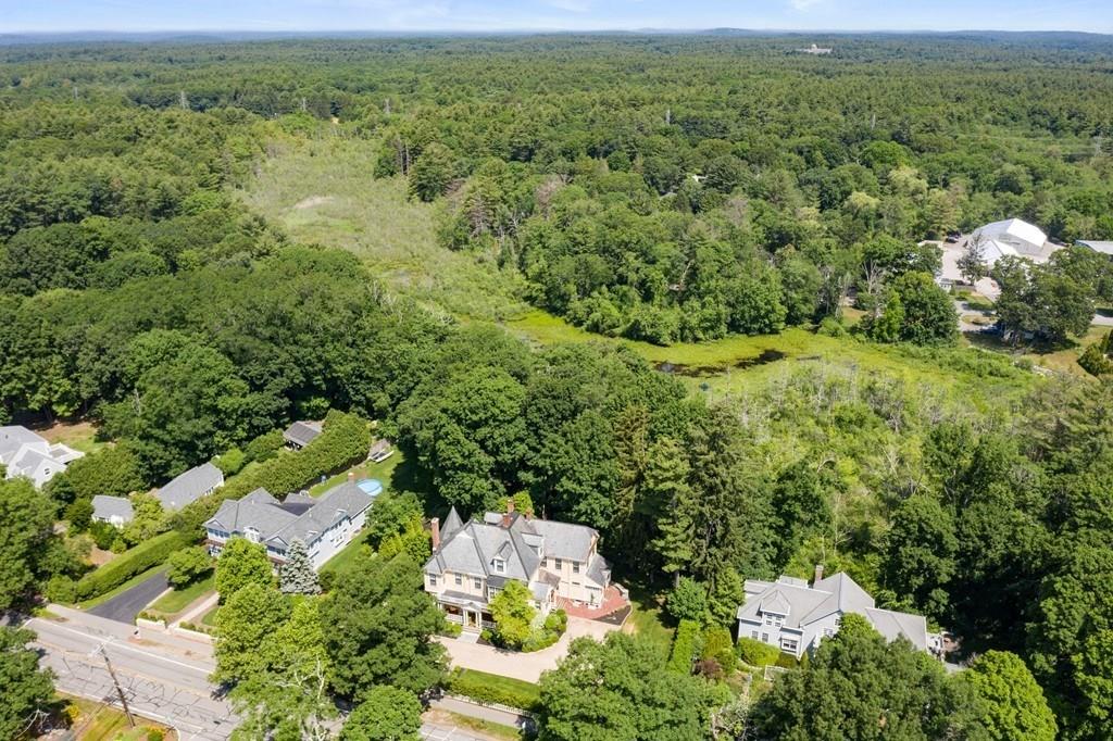 699 Boston Post Road Weston, MA 02493 - Photo 3 of 41 an aerial view of residential houses with outdoor space and trees