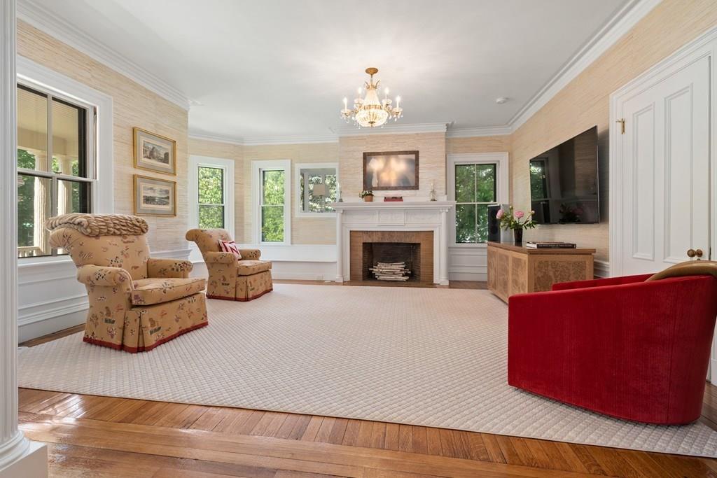 699 Boston Post Road Weston, MA 02493 - Photo 8 of 41 a living room with furniture a flat screen tv and a fireplace