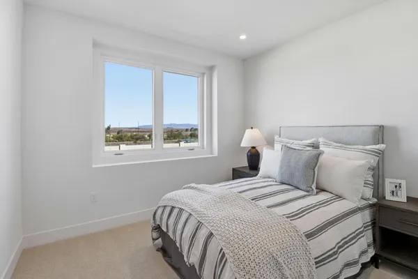 a bedroom with a bed and a window