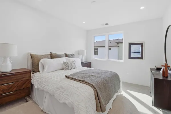 a bedroom with bed and a night stand