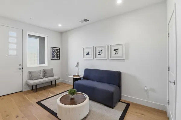 a living room with furniture and a rug