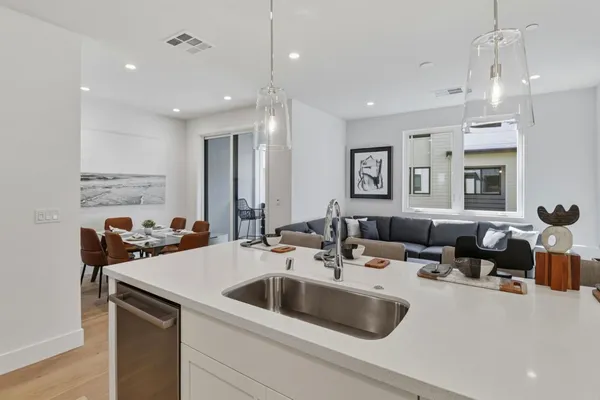 a kitchen with a sink a stove and a refrigerator