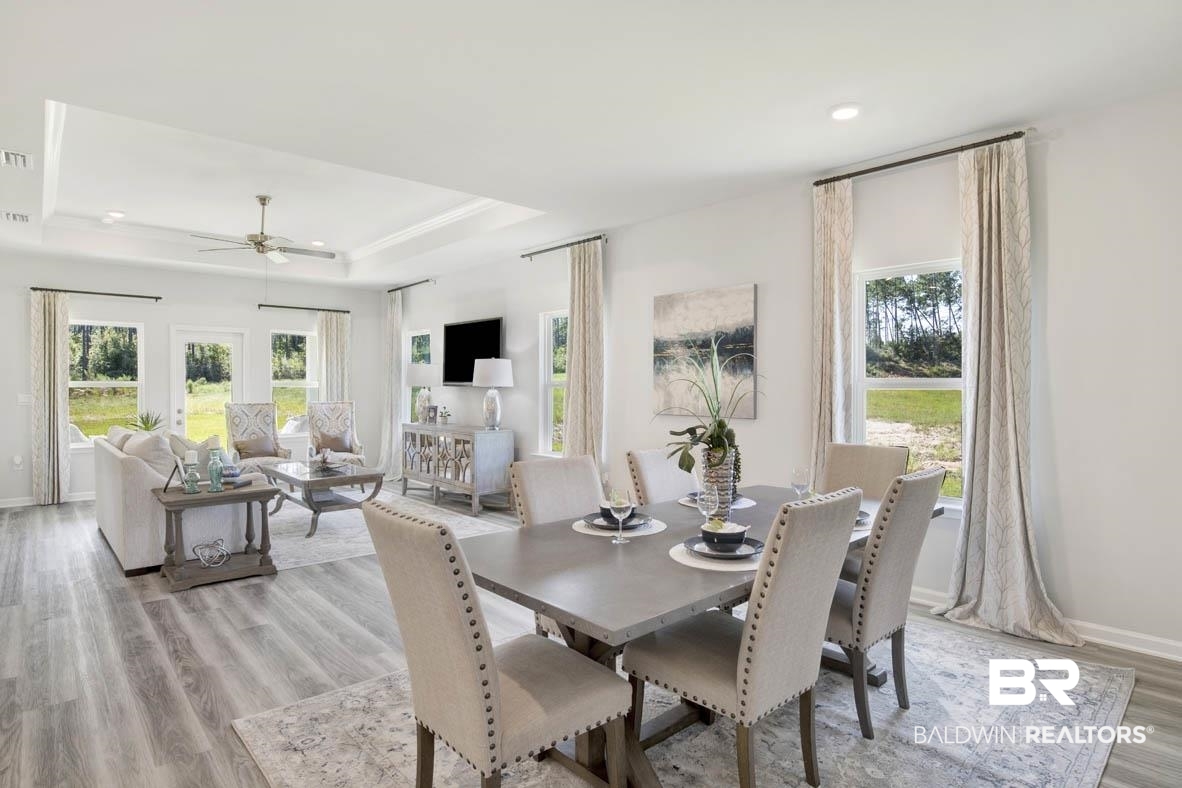 13822 Antler Hl Road Daphne, AL 36527 - Photo 23 of 39 Dining room with ceiling fan, a tray ceiling, and light hardwood / wood-style floors