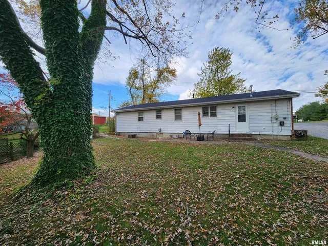 a front view of house with yard and trees