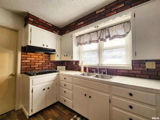 a kitchen with appliances cabinets and a window