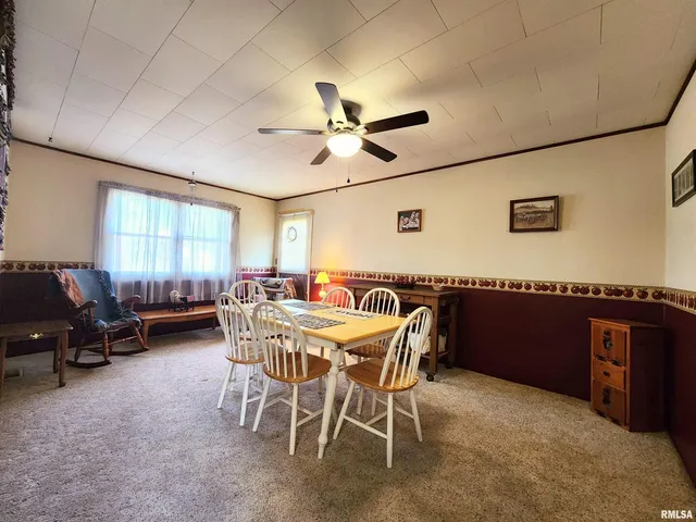a view of a livingroom with furniture and a window