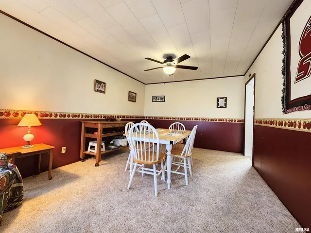a view of a dining room with furniture and a flat screen tv