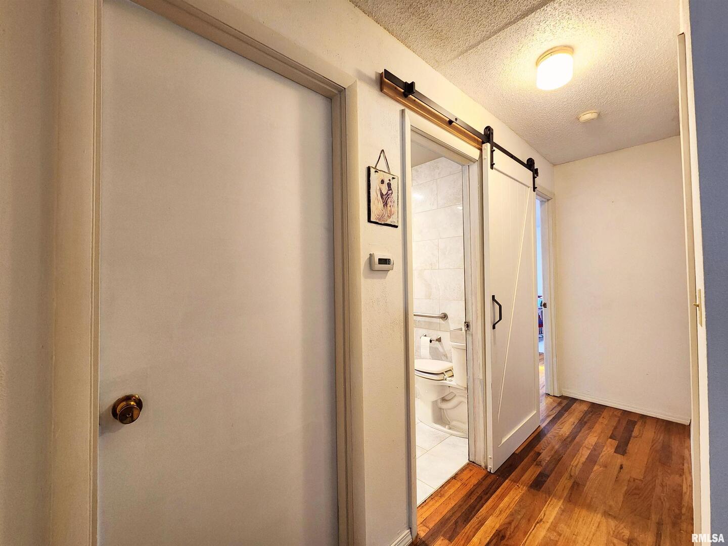 355 Chestnut Street Alto Pass, IL 62905 - Photo 9 of 26 a bathroom with a glass door shower door and a wooden floor