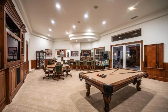 a bathroom with a granite countertop sink a mirror and shower