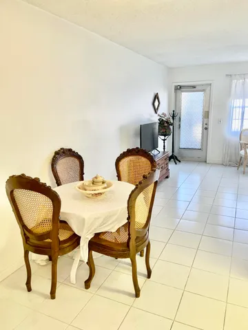 a dining room with furniture and a mirror