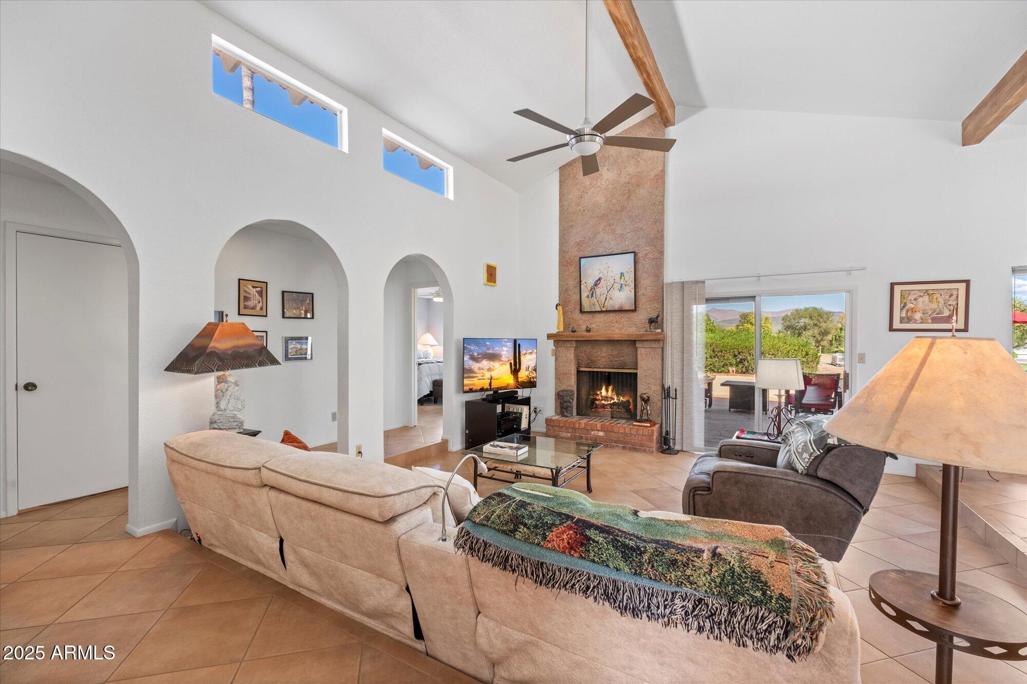 18720 East Vía Laguna Rio Verde, AZ 85263 - Photo 10 of 37 a living room with furniture and a fireplace