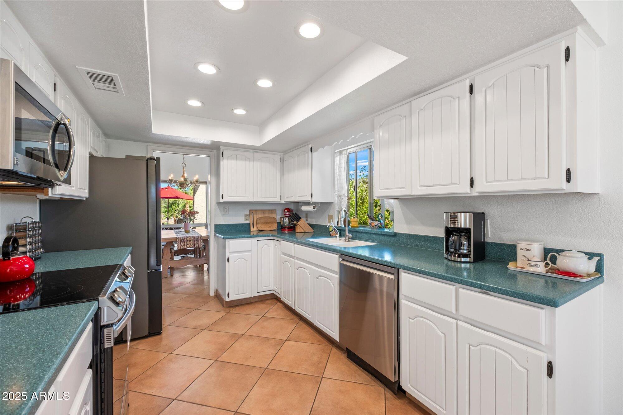 18720 East Vía Laguna Rio Verde, AZ 85263 - Photo 15 of 37 a kitchen with cabinets and window