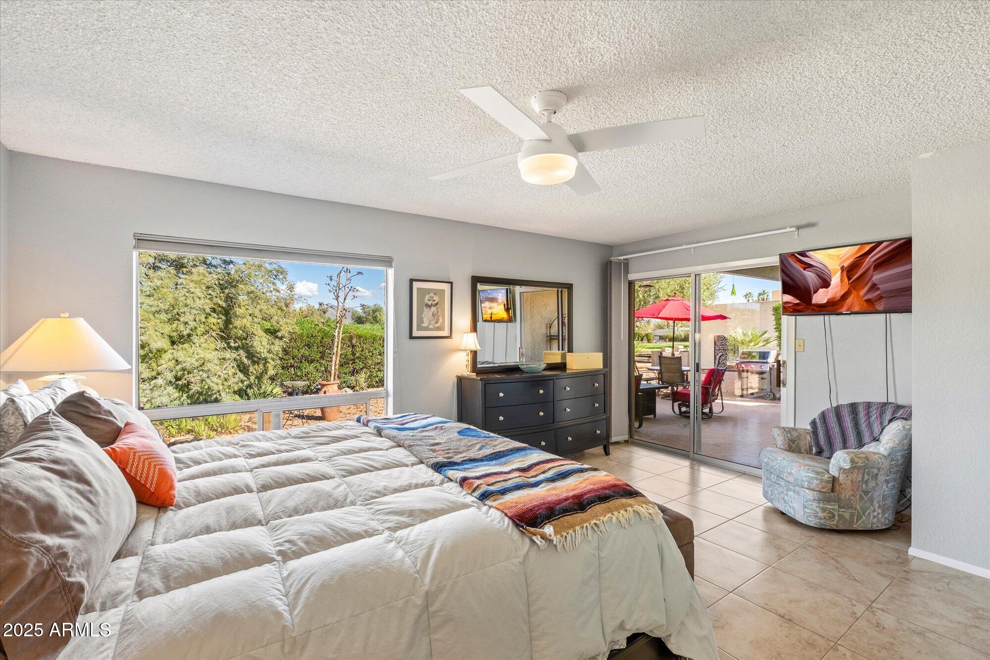 18720 East Vía Laguna Rio Verde, AZ 85263 - Photo 18 of 37 a bedroom with a bed and ceiling fan