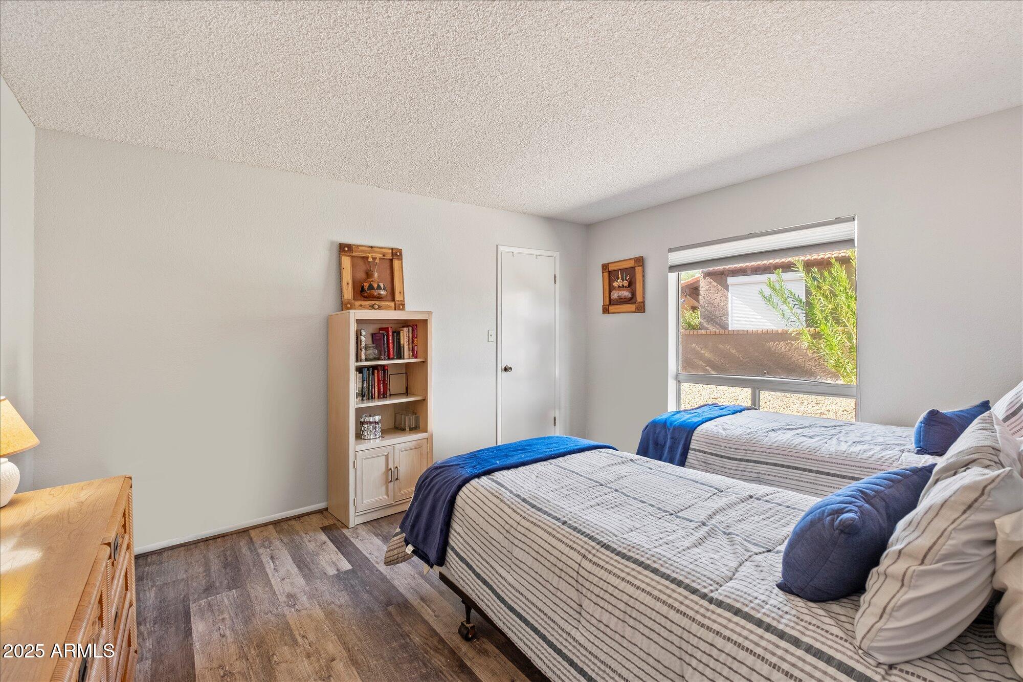 18720 East Vía Laguna Rio Verde, AZ 85263 - Photo 22 of 37 a bedroom with a bed and wooden floor