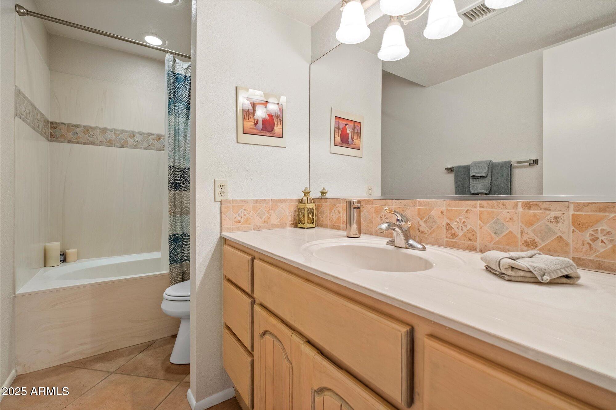 18720 East Vía Laguna Rio Verde, AZ 85263 - Photo 23 of 37 a bathroom with a granite countertop sink mirror vanity and toilet