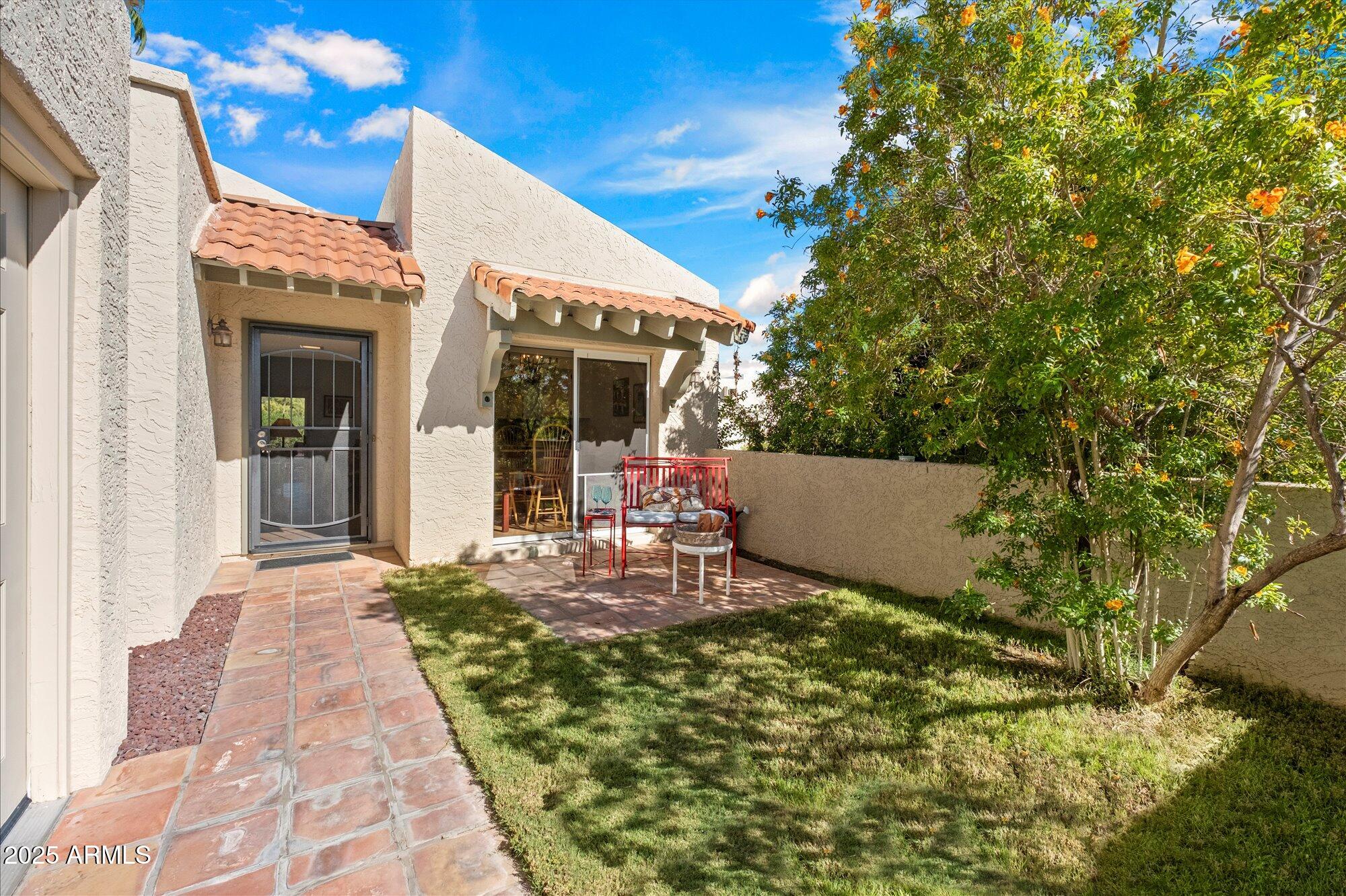 18720 East Vía Laguna Rio Verde, AZ 85263 - Photo 5 of 37 a view of a patio with table and chairs and potted plants