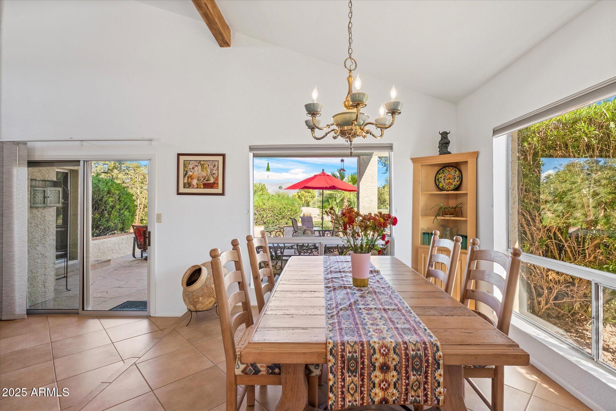 18720 East Vía Laguna Rio Verde, AZ 85263 - Photo 8 of 37 a view of a dining room with furniture wooden floor and chandelier