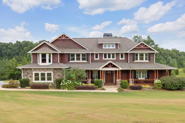 a front view of a house with swimming pool and porch