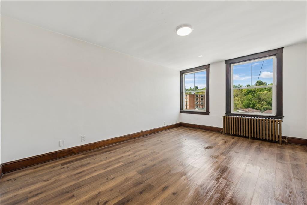 206 North Warren Avenue Apollo, PA 15613 - Photo 4 of 23 a view of an empty room with wooden floor and a window