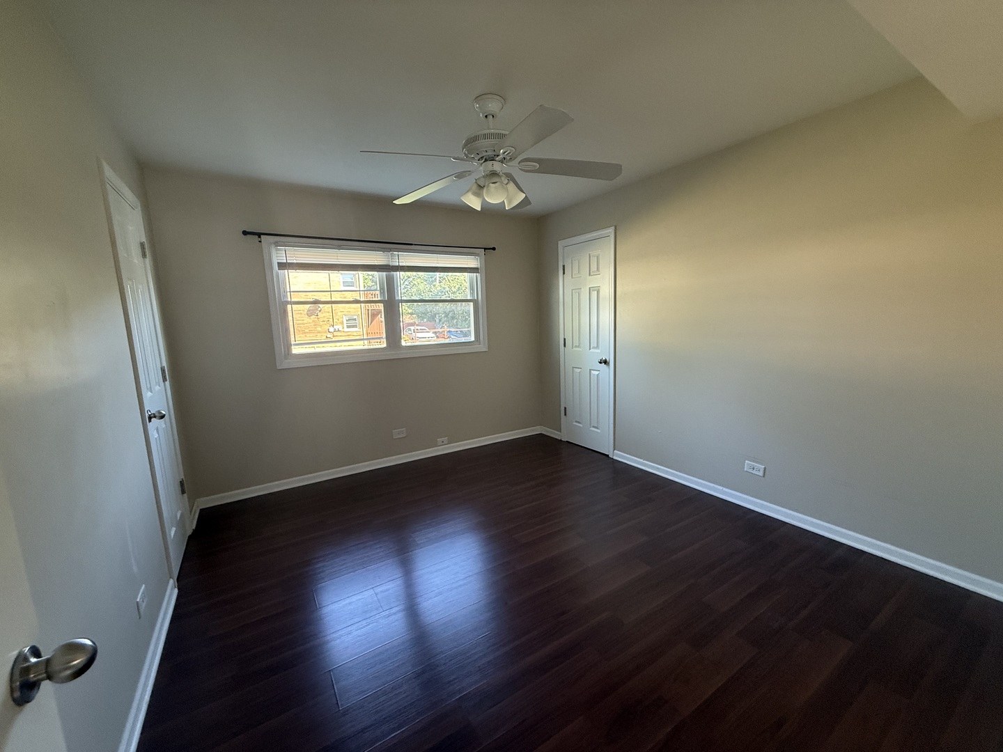 109 Central Avenue, Unit A Roselle, IL 60172 - Photo 9 of 11 an empty room with wooden floor and windows