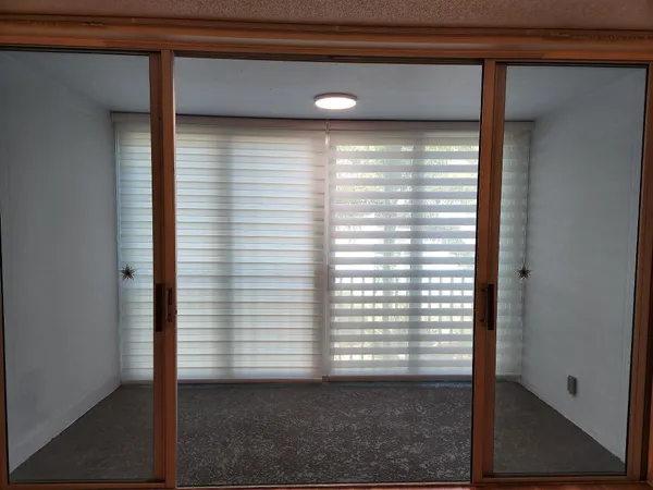 a view of a glass door and a window