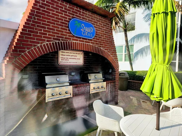 a front view of a house with yard and patio