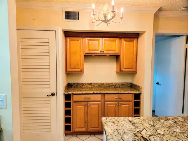 a kitchen with a stove a sink and cabinets