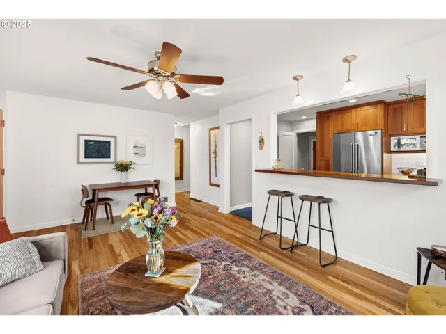 a living room with furniture and a dining table