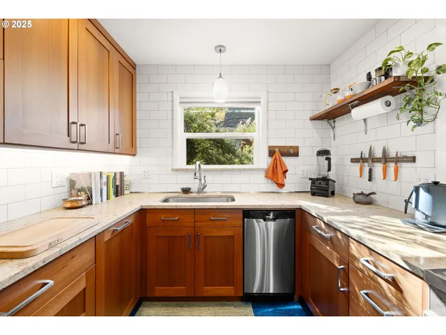 a kitchen with a sink a window and cabinets