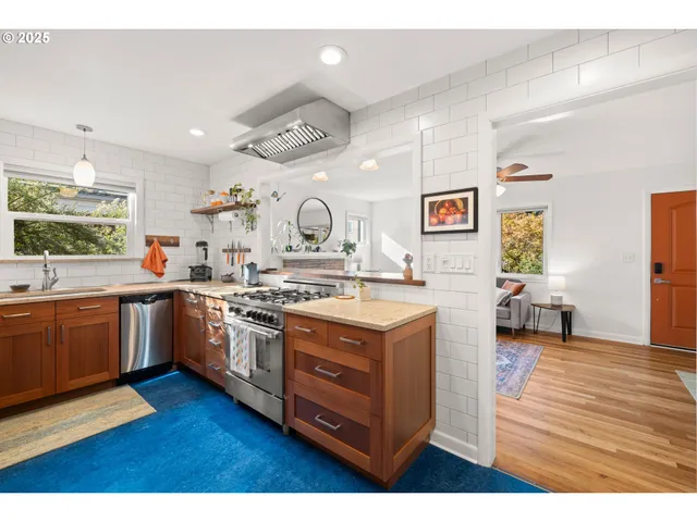 a kitchen with a sink cabinets and wooden floor