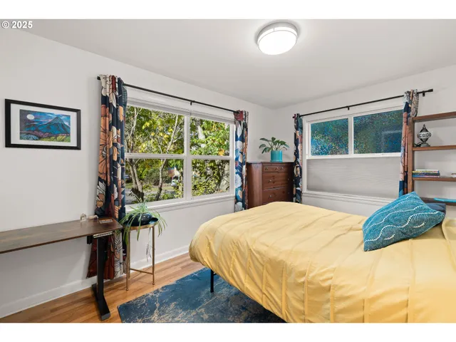 a bedroom with a large bed and a large window