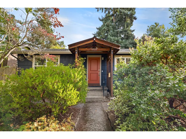 a view of a pathway of a house with a small yard and plants