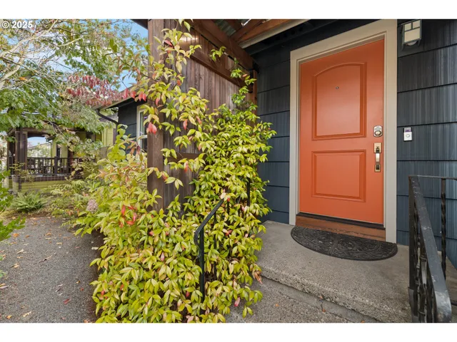 a view of a house with a door and wooden bench