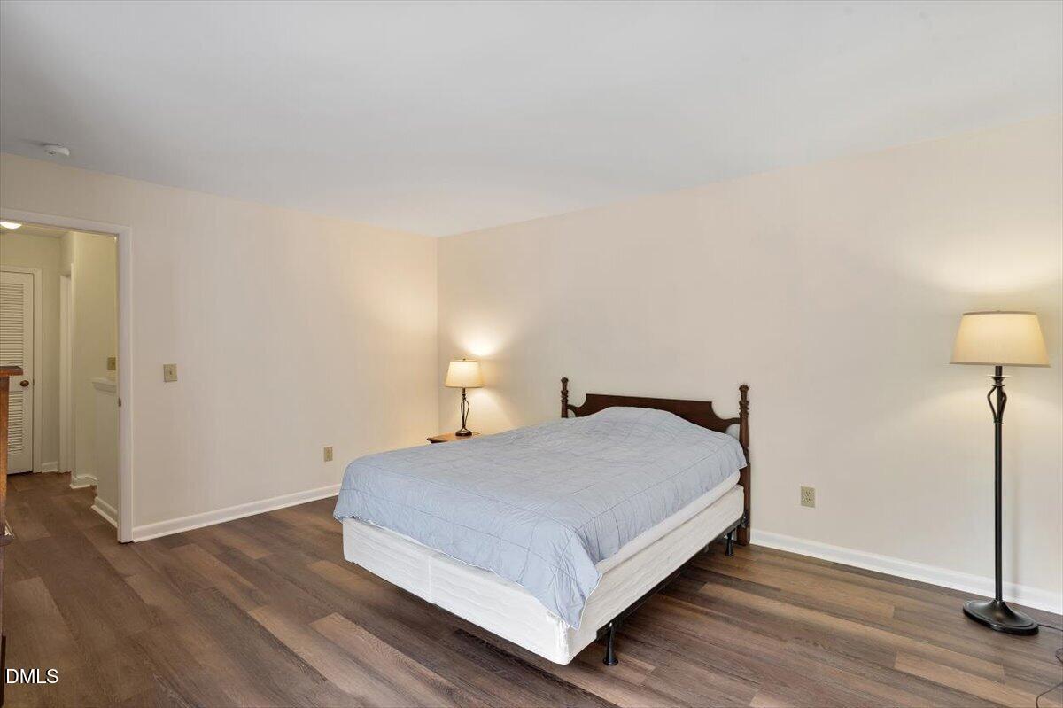 163 Springberry Lane Chapel Hill, NC 27517 - Photo 18 of 32 a bedroom with a bed and a lamp