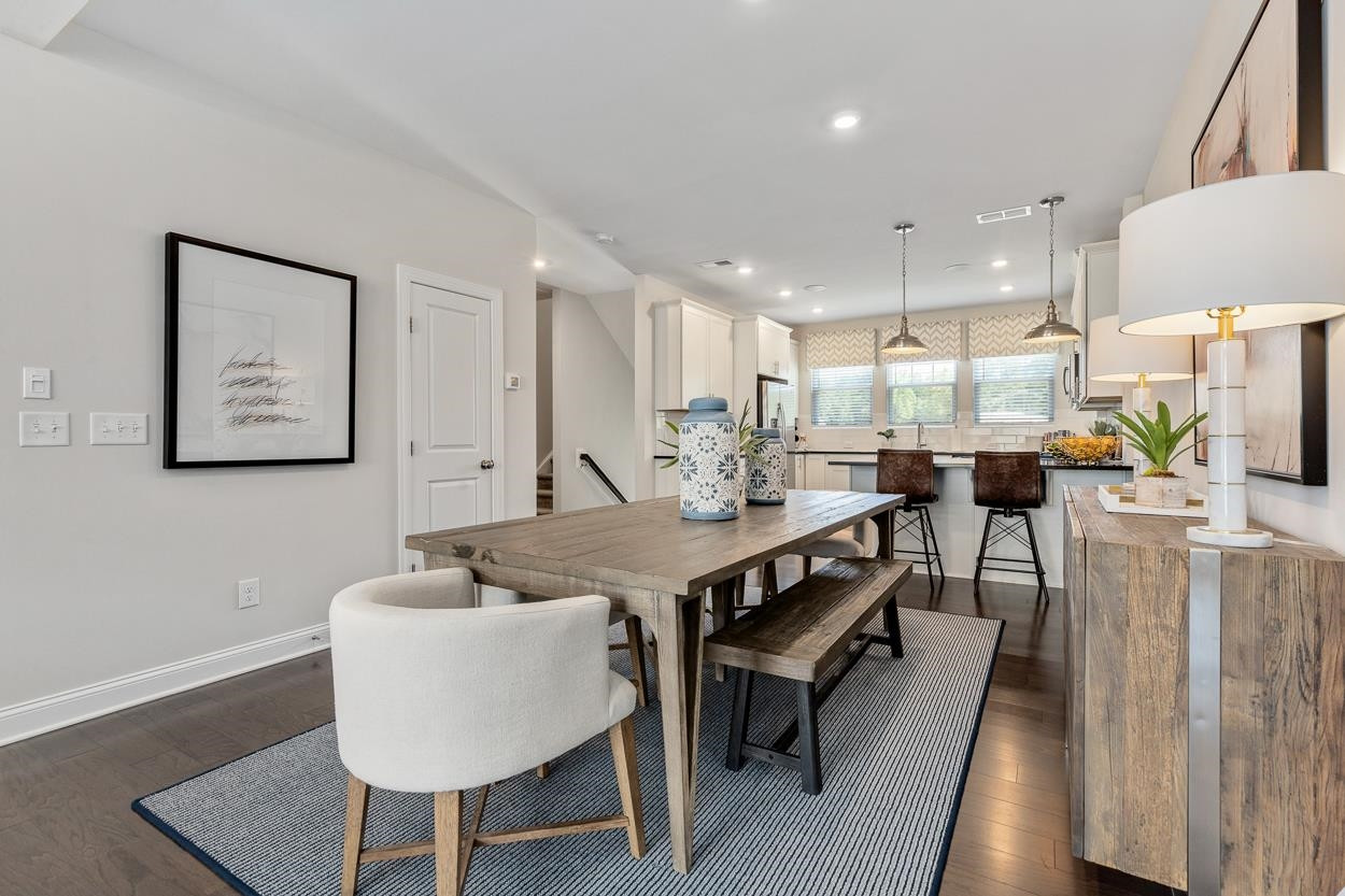 1002 Royal Mill Avenue Wake Forest, NC 27587 - Photo 12 of 51 a view of a kitchen with kitchen island stainless steel appliances a sink table and chairs