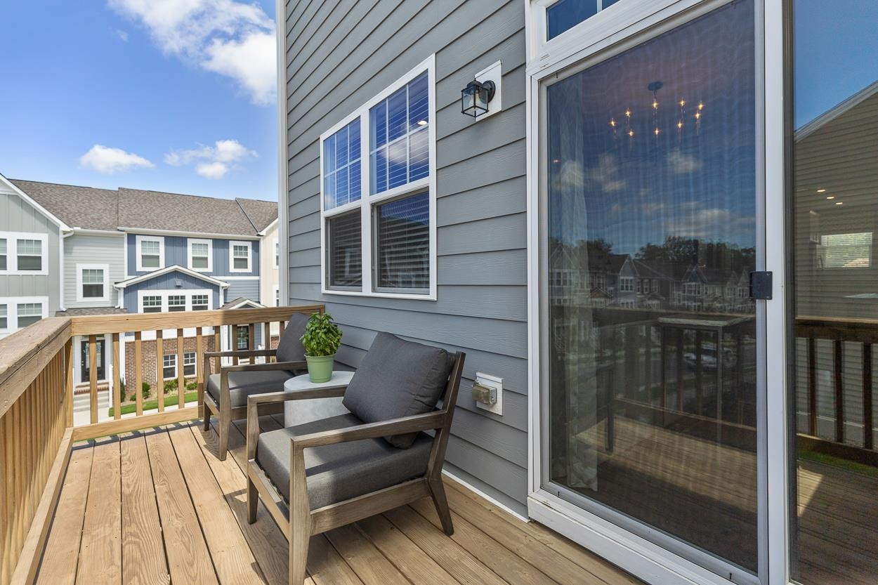 1002 Royal Mill Avenue Wake Forest, NC 27587 - Photo 18 of 51 a balcony with wooden floor and furniture