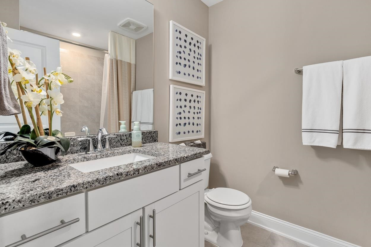 1002 Royal Mill Avenue Wake Forest, NC 27587 - Photo 28 of 51 a bathroom with a granite countertop sink mirror vanity and toilet