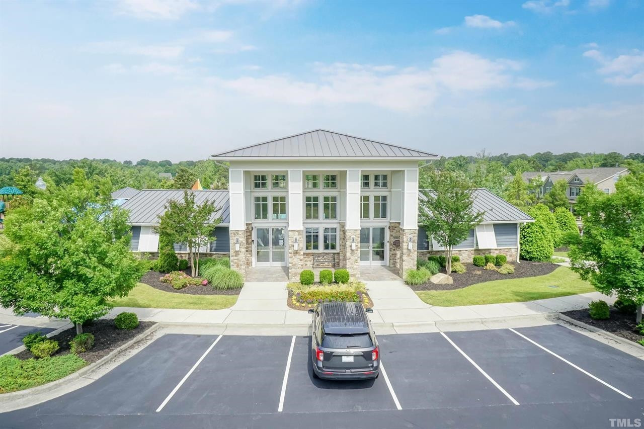 1002 Royal Mill Avenue Wake Forest, NC 27587 - Photo 47 of 51 a view of a house with a swimming pool and a lawn chairs next to a yard