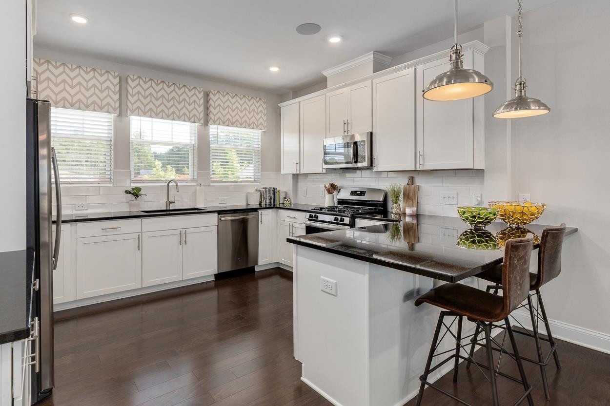 1002 Royal Mill Avenue Wake Forest, NC 27587 - Photo 8 of 51 a kitchen with a sink cabinets and window