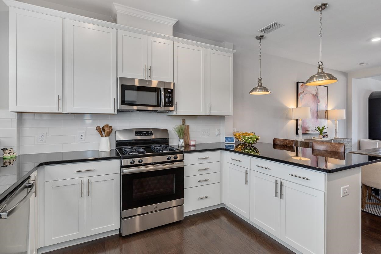 1002 Royal Mill Avenue Wake Forest, NC 27587 - Photo 9 of 51 a kitchen with white cabinets and white appliances