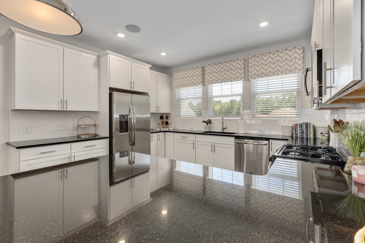 1002 Royal Mill Avenue Wake Forest, NC 27587 - Photo 10 of 51 a kitchen with stainless steel appliances granite countertop a stove a sink and a refrigerator