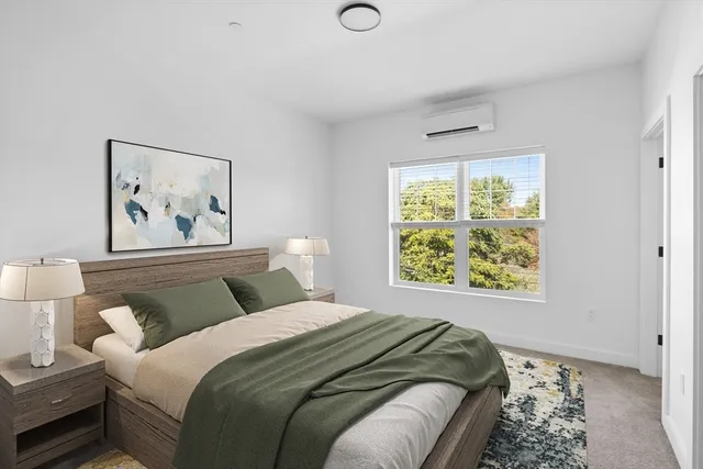 a bedroom with bed and a window