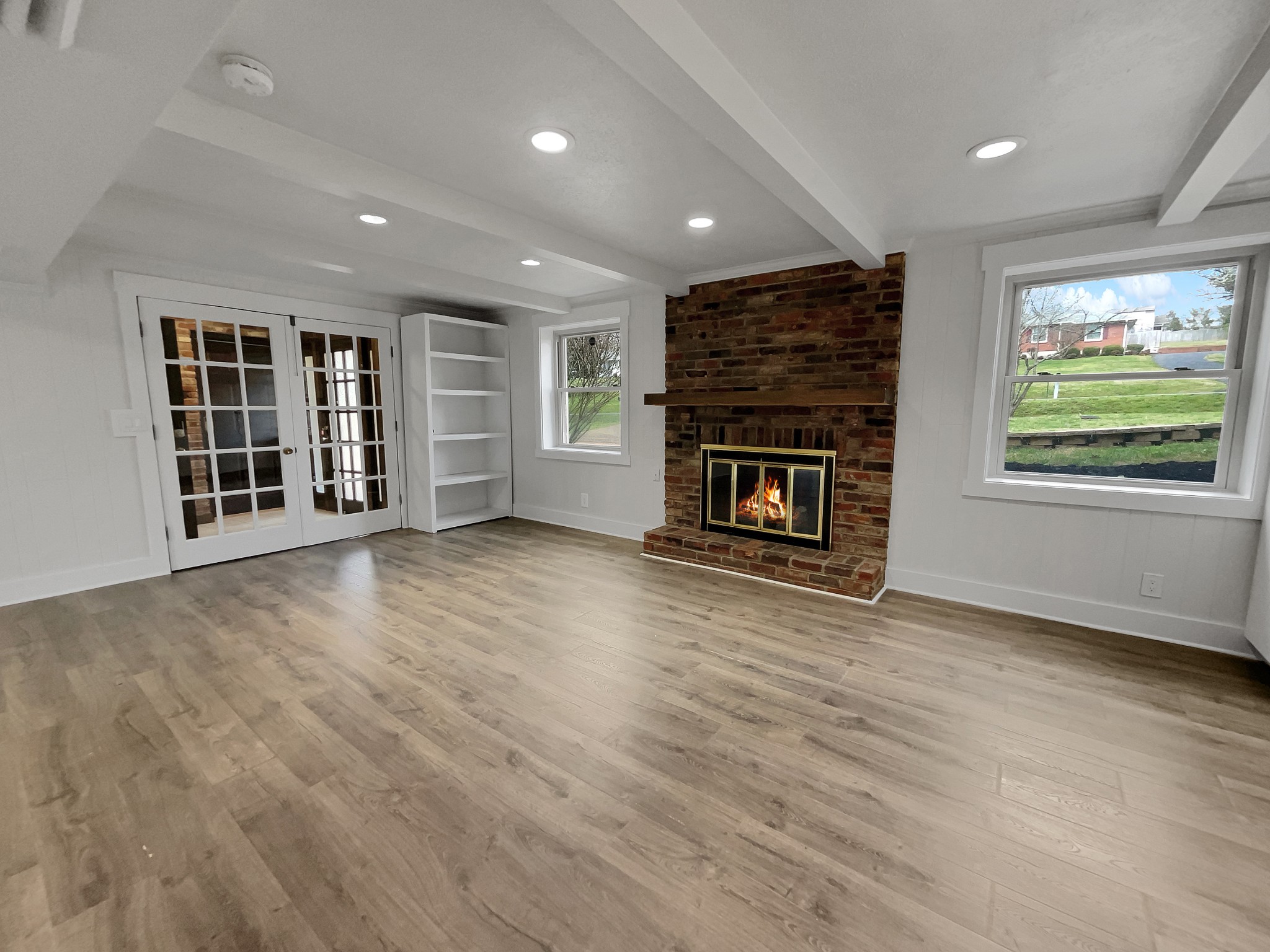 158 Spring Valley Road Nashville, TN 37214 - Photo 3 of 29 an empty room with windows fireplace and wooden floor