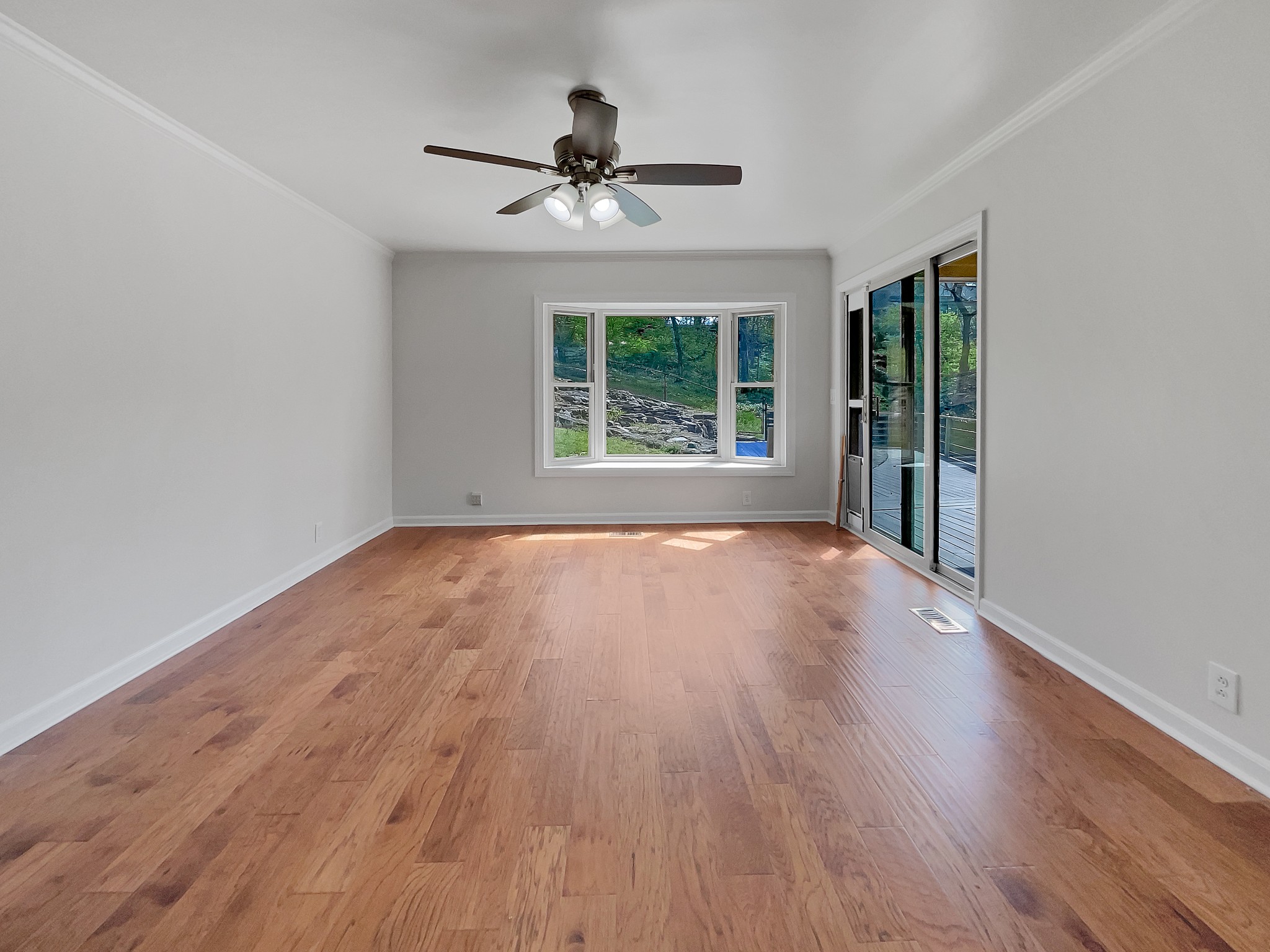 158 Spring Valley Road Nashville, TN 37214 - Photo 5 of 29 a view of an empty room with wooden floor and a window