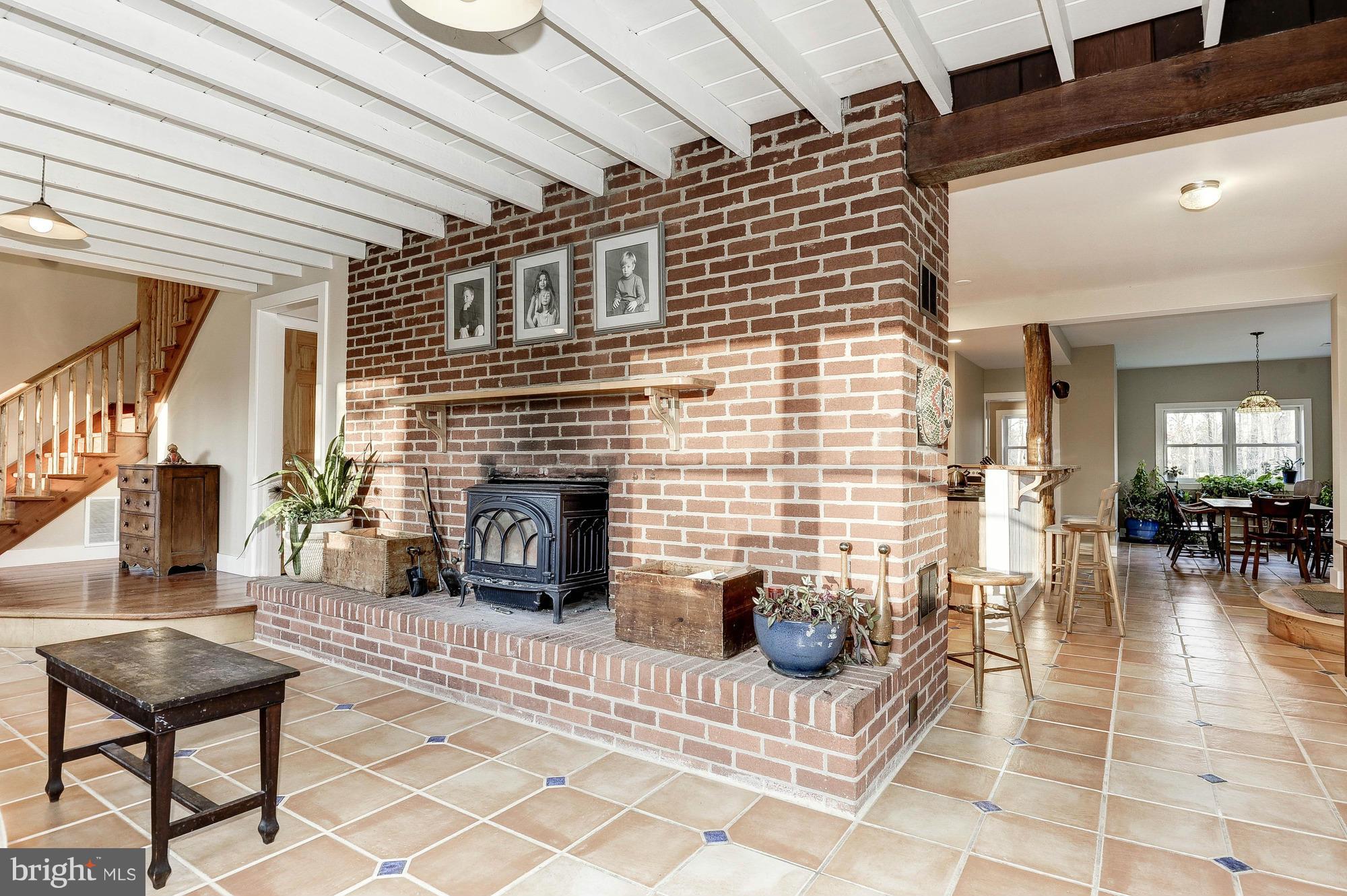 19820 Telegraph Springs Road Purcellville, VA 20132 - Photo 8 of 30 Brick fireplace and woodstove