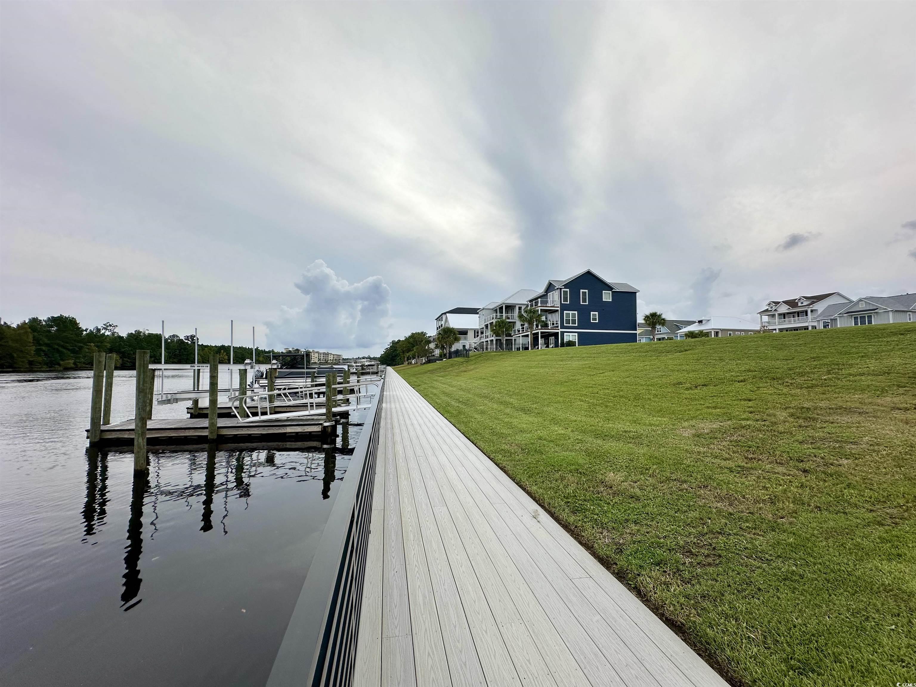 469 Harbour View Drive Myrtle Beach, SC 29579 - Photo 7 of 17 View of dock with a lawn and a water view
