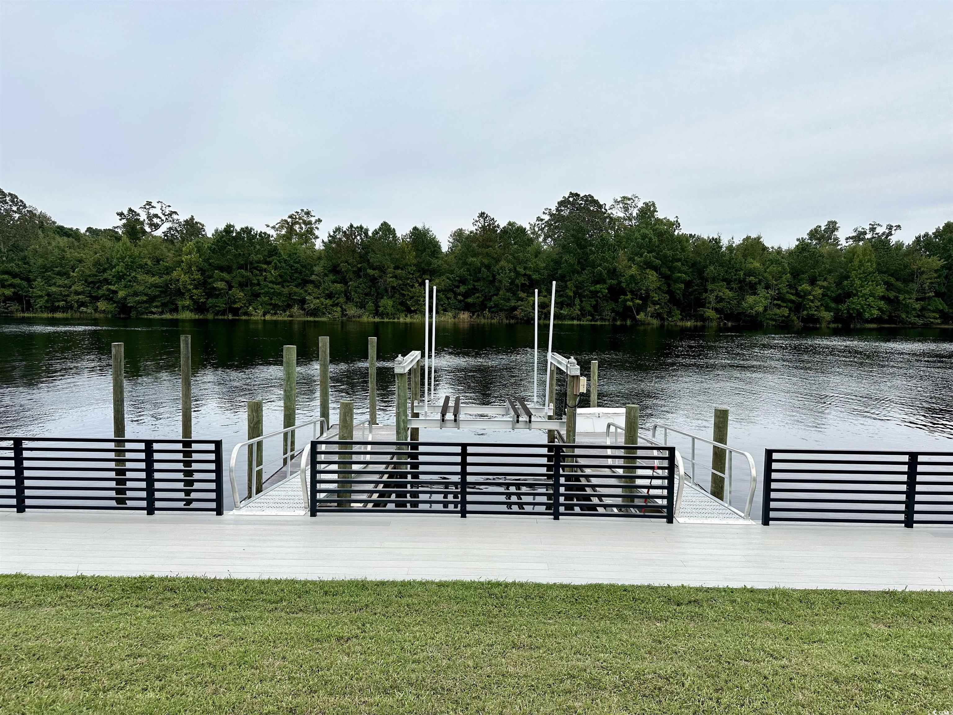 469 Harbour View Drive Myrtle Beach, SC 29579 - Photo 9 of 17 View of dock featuring a water view and a yard