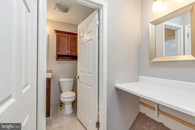 a bathroom with a sink a toilet and a window